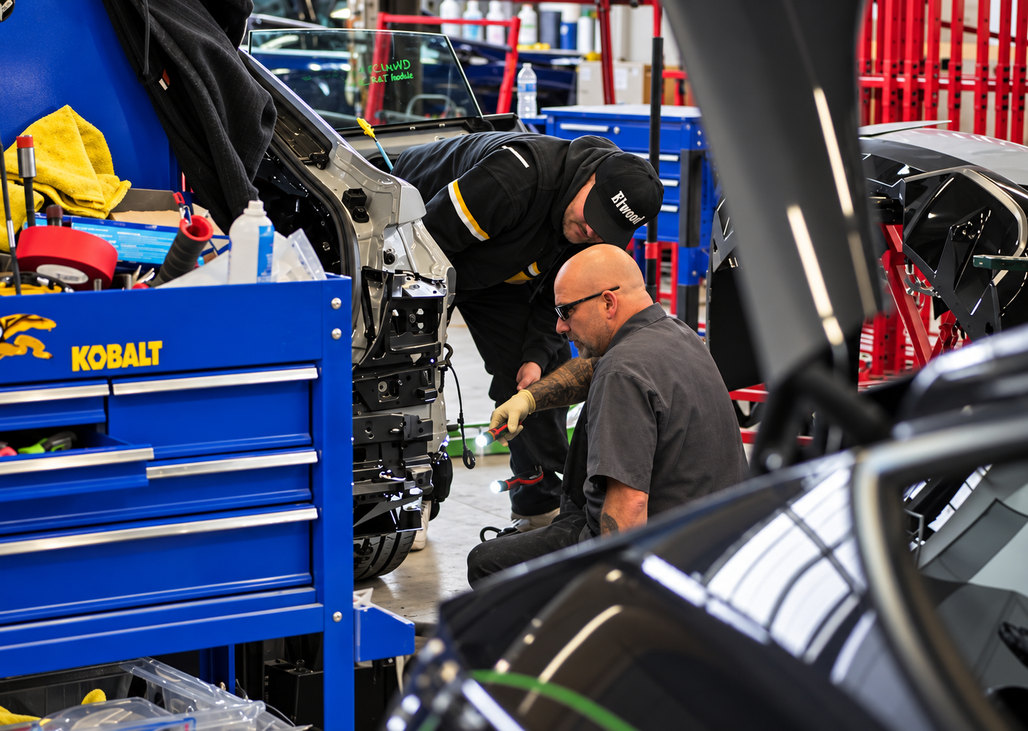 Pacific Auto Body technicians working together on a vehicle